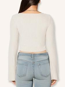 Back view of slim fit cream long sleeve crop top with ribbed texture and back details