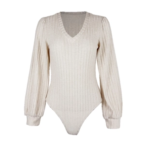Close-up of beige ribbed knit texture on v-neck bodysuit with lantern sleeves