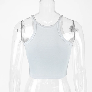 Detail view of the white ribbed knit cotton racerback crop top on a clear mannequin