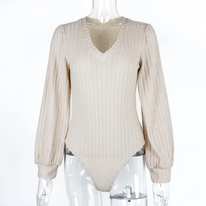 Detailed view of oatmeal knit bodysuit featuring deep V-neck and puff lantern sleeves