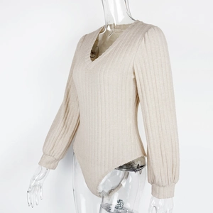 Detail view of beige ribbed knit bodysuit featuring V-neckline and lantern sleeve texture