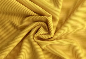 Close-up of bright yellow ribbed knit fabric texture with elegant vertical stripes
