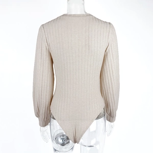 Detailed back view of apricot ribbed knit bodysuit featuring long sleeves and fitted silhouette