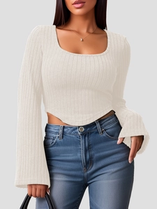 Close-up of ribbed knit top featuring a square neck and unique curved triangle hemline