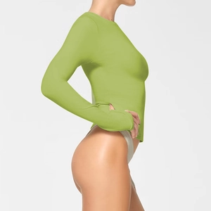 Detail view of the side profile showing the slim fit and green fabric of this long sleeve top