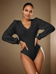 Detail view of black ribbed knit bodysuit featuring elegant V-neck and puff long sleeves