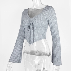 Detail of light grey ribbed knit crop top with V-neckline and front drawstring texture