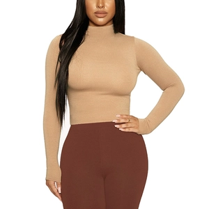 Close-up of slim fit mock neck long sleeve knit top in warm camel color fabric