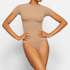 Detailed close-up of skin-tone slim fit crew neck T-shirt with high elasticity fabric