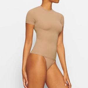 Detail of slim-fit bodysuit in light coffee with seamless elastic fabric side view