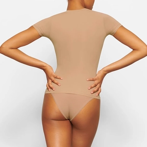 Close-up back view of nude slim fit bodysuit featuring seamless stretch fabric and smooth finish
