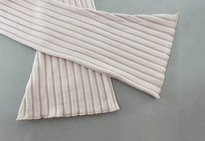 Detailed view of the wide rib-knit texture on this soft beige autumn winter crop top