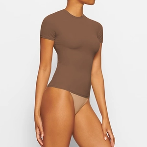Detailed view of the slim-fit brown short-sleeve top showing smooth elastic fabric