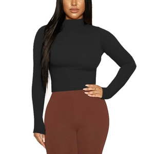 Close-up of women's slim fit mock neck long sleeve crop top in premium black fabric