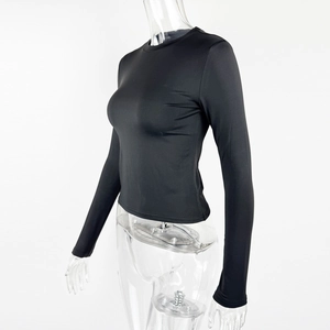 Detail view of black slim fit crop top showing fine ribbed texture and elastic fabric