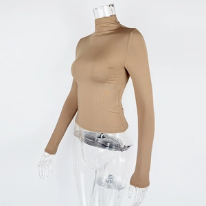 Side view of khaki slim fit long sleeve turtleneck top with premium elastic fabric