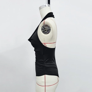Detail of black cowl neck bodysuit showing side drawstring ruching on a mannequin