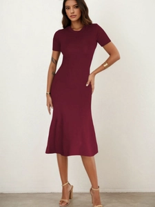 Detail of elegant wine red slim fit A-line dress showing the stylish fishtail hemline
