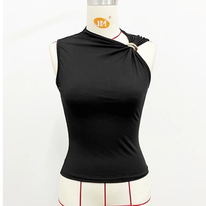 Detail of black slim-fit vest with asymmetric neckline and golden metal rings decoration