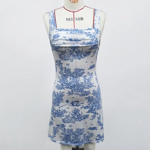 Detail of square neck and vintage blue floral toile pattern on white sleeveless mini dress