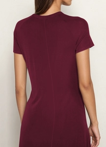 Rear view of a slim fit wine red A-line dress with short sleeves and a vertical seam