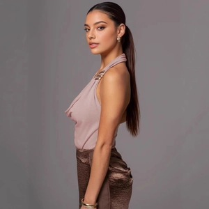 Close-up of pink satin halter top featuring draped neckline and gold metal buckle details
