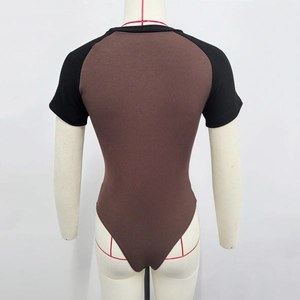 Close-up of brown ribbed knit bodysuit with black raglan sleeves on a mannequin