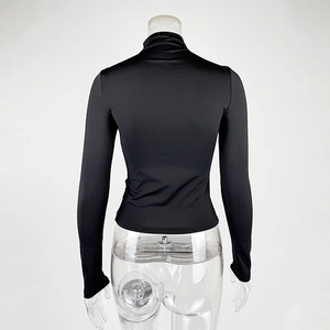 Detail view of the black slim fit turtleneck top with smooth elastic fabric from behind