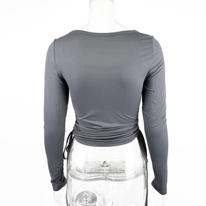 Detail view of charcoal grey cropped top featuring adjustable side drawstrings and ruched texture