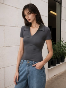 Detail of dark grey ribbed knit polo T-shirt with V-neck and slim fit street style