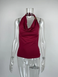 Detail of wine red halter top featuring a cowl neck and elegant gold metal ring accents