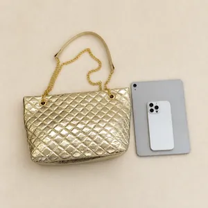 Quilted gold tote bag with chain strap shown next to a tablet for size comparison