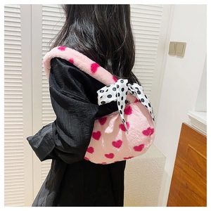 Back view of pink plush heart shoulder bag with black and white polka dot bow
