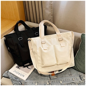 Macro shot of minimalist black and beige canvas tote bags on a sofa in a Nordic style setting