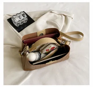 Top view of the light brown quilted crossbody bag showing spacious interior capacity