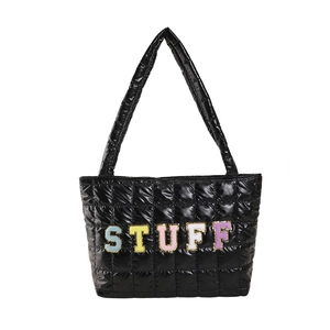 Quilted black tote bag with colorful STUFF embroidery and glossy fabric finish