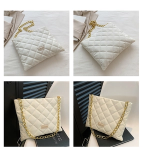 Close-up of beige quilted crossbody bag with diamond pattern and gold chain strap detail