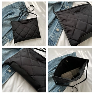 Detailed interior view of black quilted crossbody bag showing capacity for phone and wallet