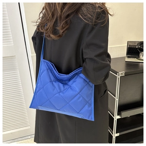 Deep blue quilted oxford tote bag shown in use with large capacity for commuting
