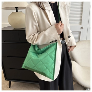Close-up of vibrant green quilted oxford fabric with detailed diamond stitching patterns