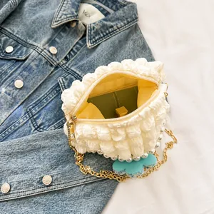 Detail of white puff bag showing interior capacity for wallet and lipstick with pearl chain