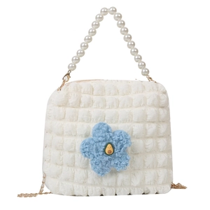 White bubble textured shoulder bag with pearl handle and blue plush flower charm