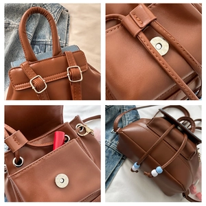 Close-up of brown faux leather backpack magnetic snap and drawstring closure detail