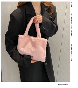 Detailed macro view of soft pink faux fox fur texture on a fashion tote handbag