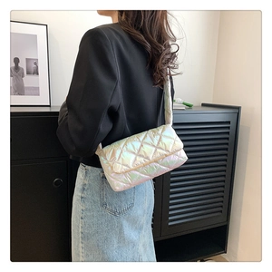 Detail view of a holographic quilted shoulder bag featuring iridescent finish and sleek strap