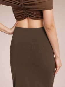 Brown bodycon long skirt with V-waist and twist detail shown from a back view