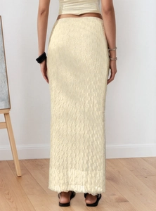 Detail view of the vertical wave texture on a beige mesh jacquard long skirt back