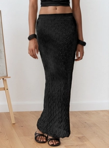 Close-up of black mesh jacquard long skirt with vertical wave texture and slim fit