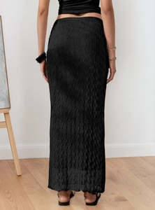 Detail of black mesh jacquard maxi skirt with vertical wavy texture and slim fit design