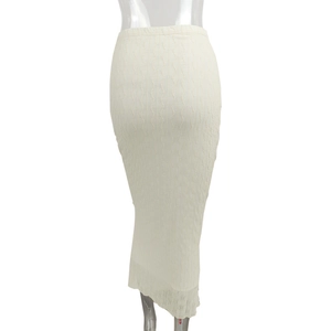 Detail shot of the cream mesh maxi skirt featuring a unique 3D wavy textured knit pattern